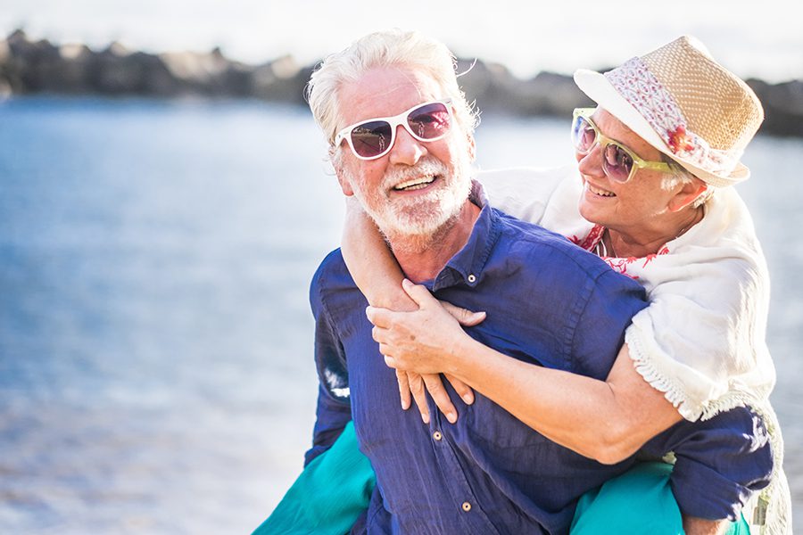 Micco, FL - Happy Senior Couple Having Fun and Enjoying Outdoors at the Beach
